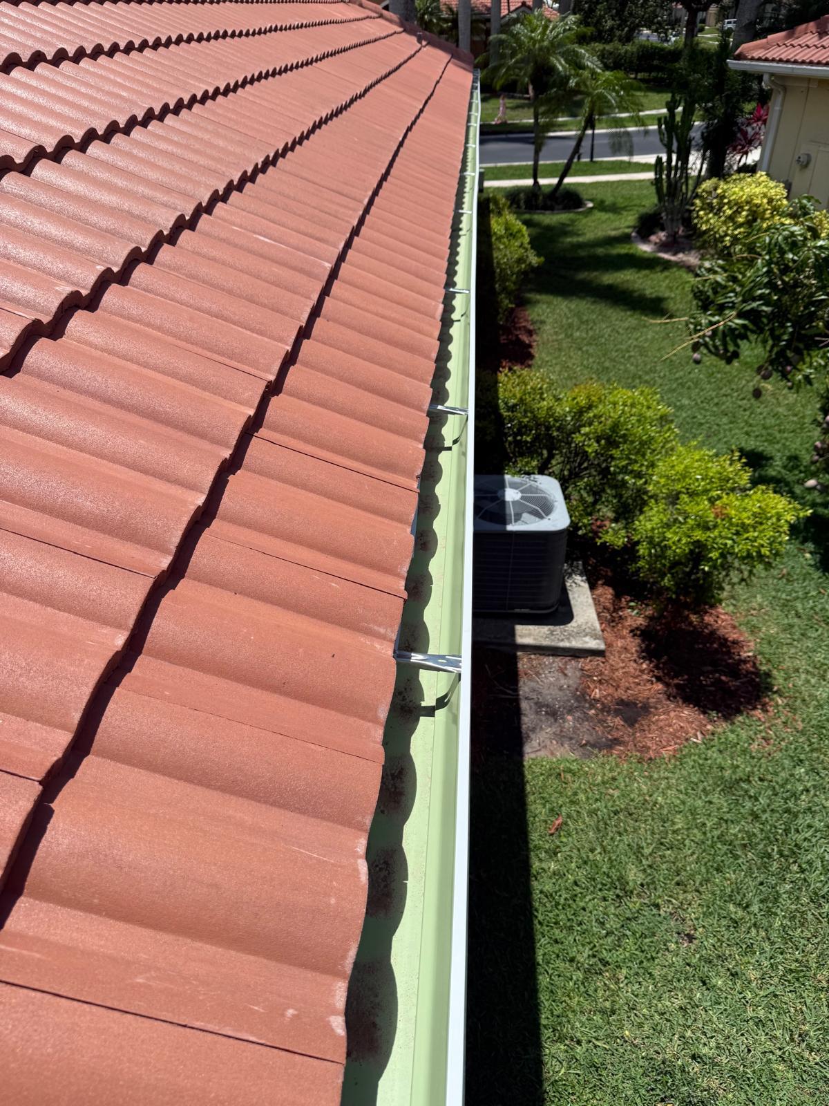 Roofing worker on flat roof doing repairs